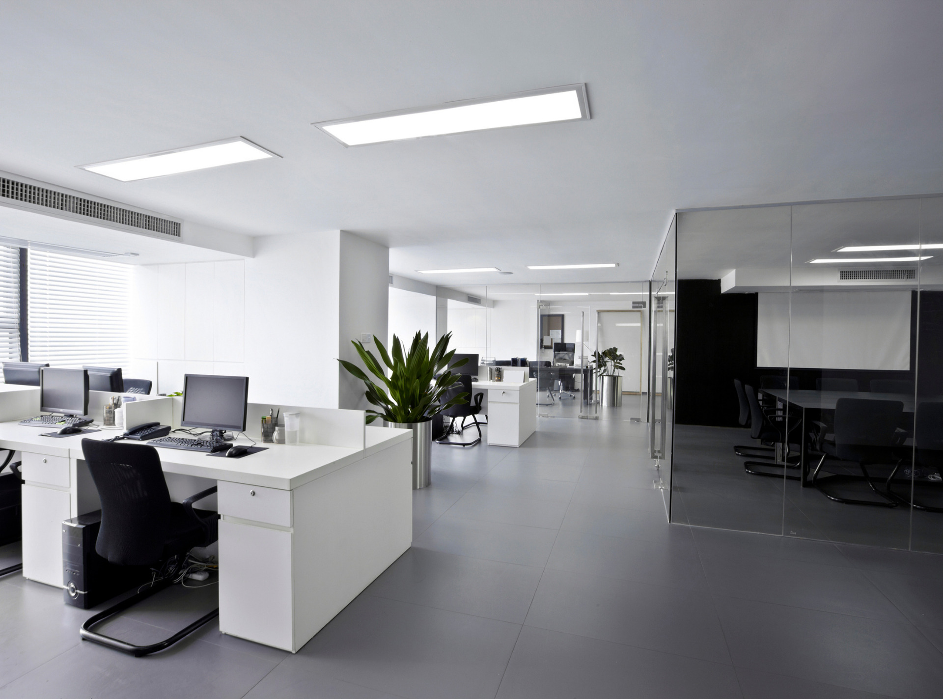 modern office with crisp white desk and black chairs